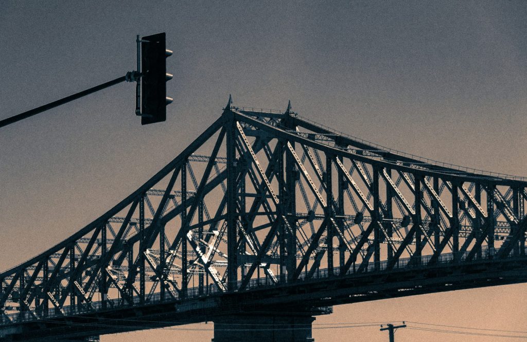 black steel bridge under gray sky